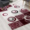 Modern rug with red and black circular patterns.