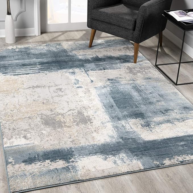 Modern abstract blue and gray area rug in room.
