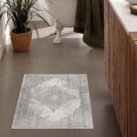 Stylish bathroom with decorative floor rug and plant