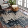 Modern abstract rug in cozy living room setting.