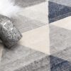 Geometric-patterned rug with decorative silver bottle.
