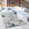 Modern living room with abstract rug and sofa.