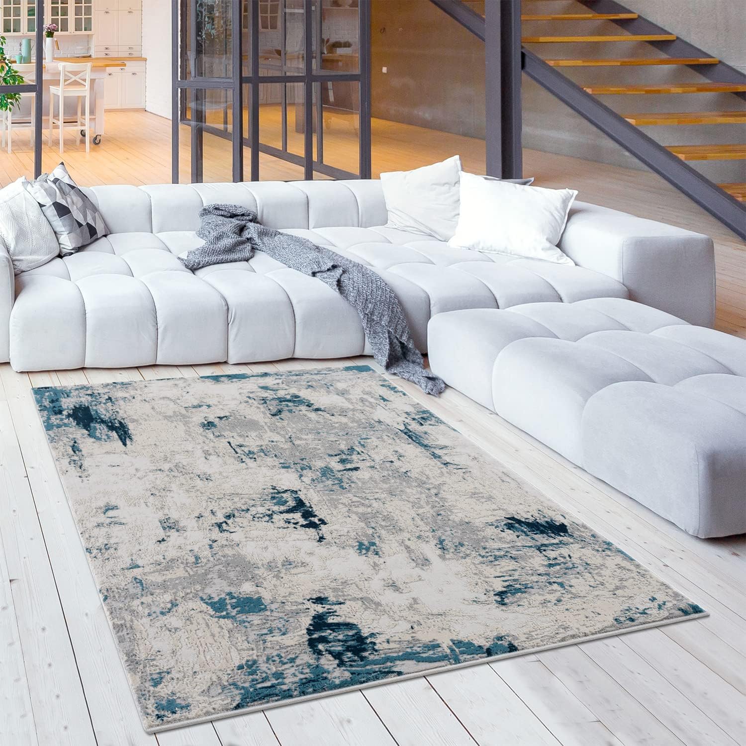 Modern living room with abstract rug and sofa.