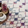 Coffee on tray with floral carpet design.
