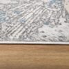 Gray and blue textured rug on wooden floor