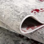 Detailed view of folded textured rug.