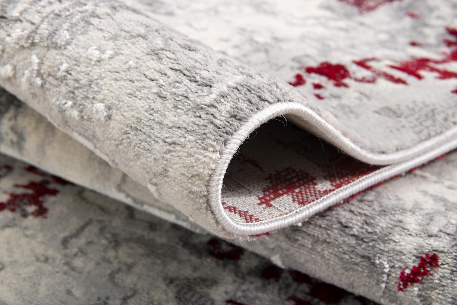 Detailed view of folded textured rug.