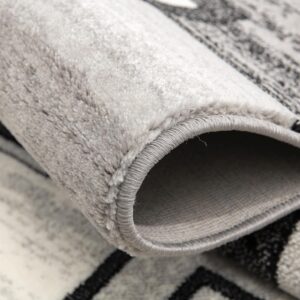 Close-up of rolled gray patterned rug.