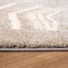 Close-up of beige carpet on wooden floor.