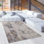 Modern living room with large rug and sofa.