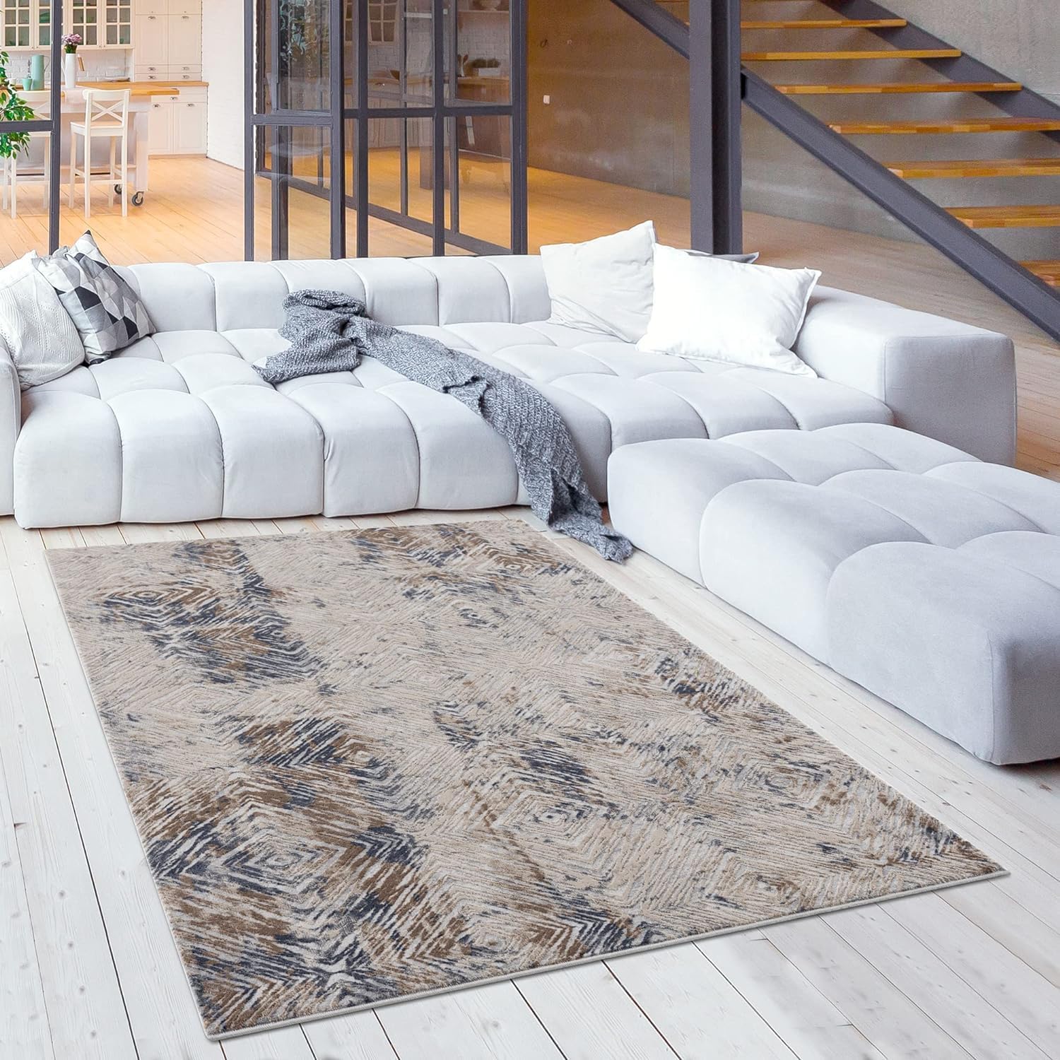 Modern living room with large rug and sofa.