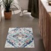 Decorative bathroom rug with intricate blue pattern.