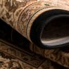 Rolled floral patterned rug close-up