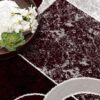 Open book on patterned maroon and gray rug
