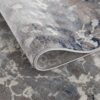 Close-up of a rolled-up patterned rug.