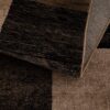 Close-up of folded textured brown and black rug