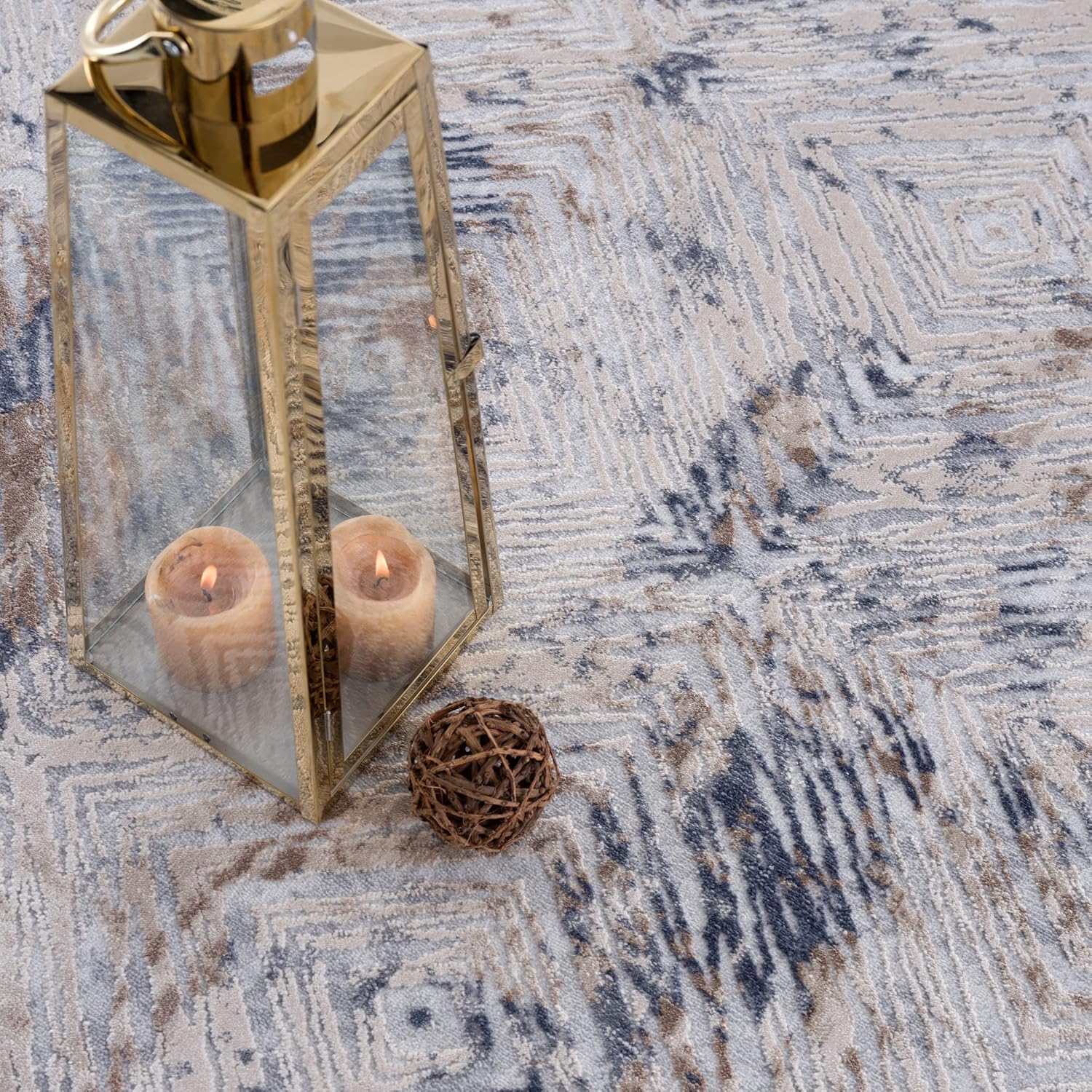 Lantern with candles on patterned rug.