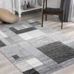 Modern geometric gray rug in a sunlit room.