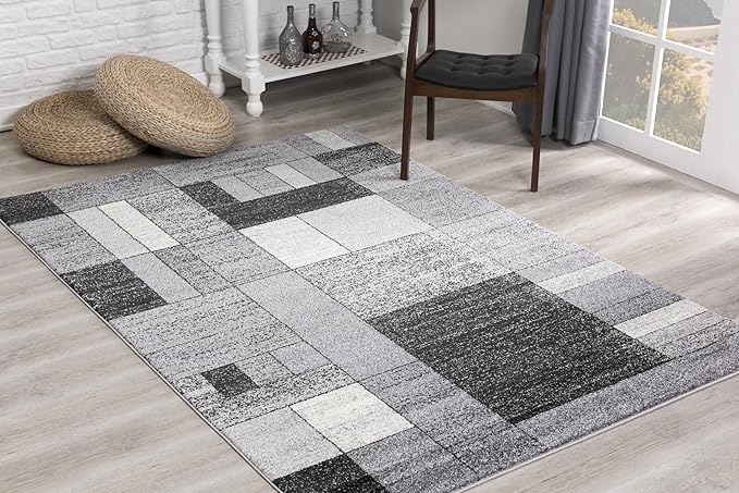 Modern geometric gray rug in a sunlit room.