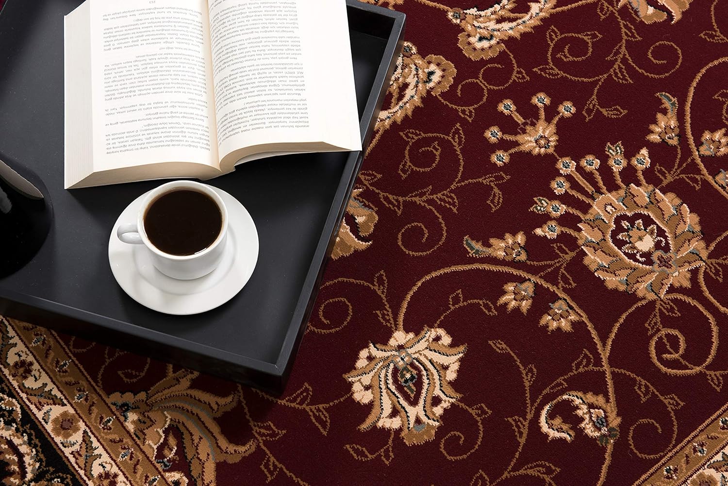 Open book and coffee on ornate carpet