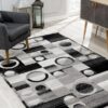 Geometric black and gray rug in modern living room.