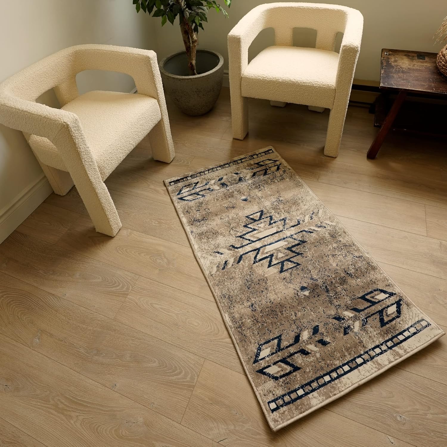 Cozy room with chairs, plant, and patterned runner rug.