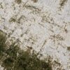Abstract green and beige textured carpet design.