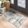 Abstract modern rug on wooden floor near doors.
