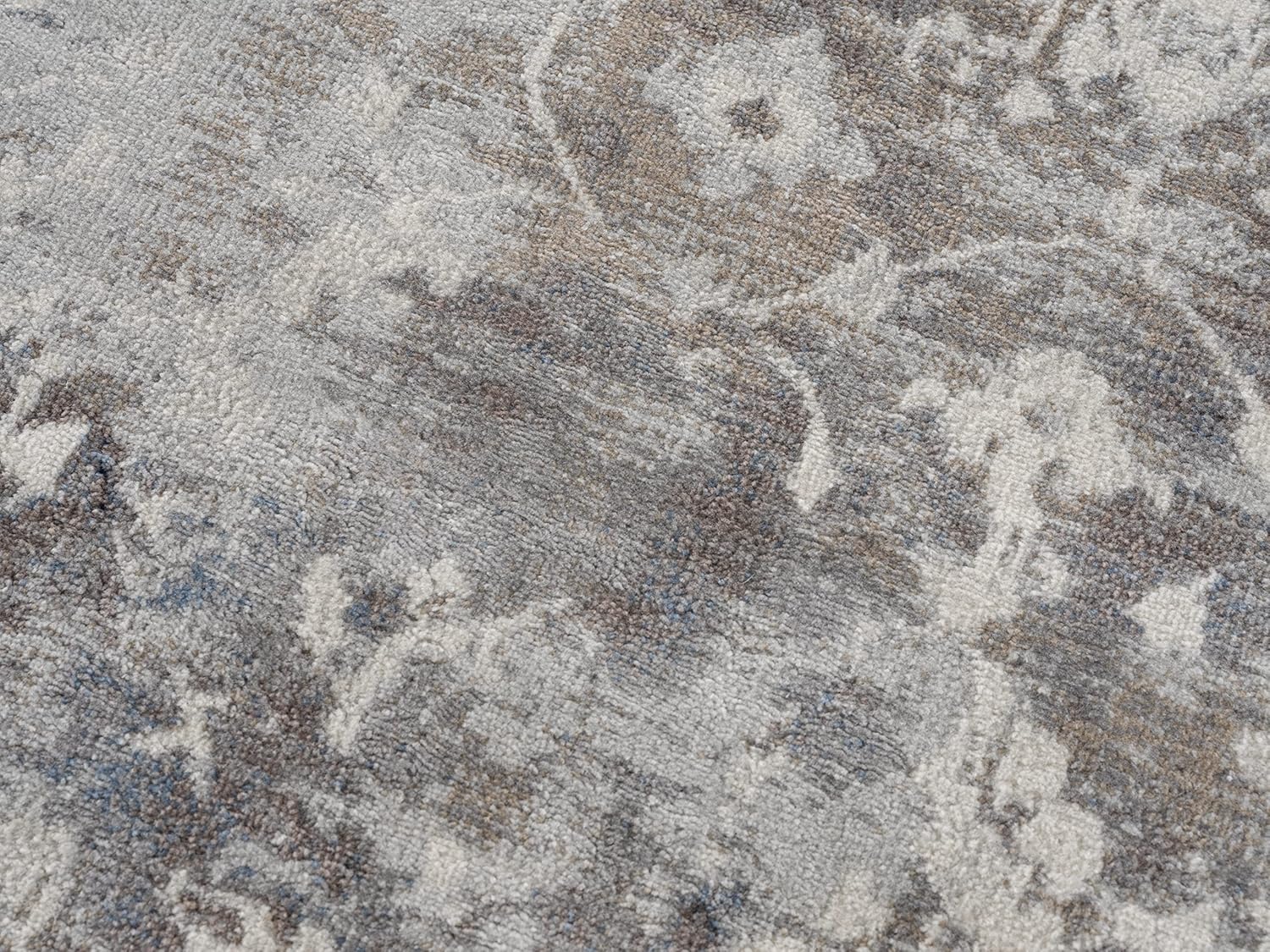 Close-up of textured gray floral carpet.