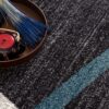 Textured carpet with teapot and book display.