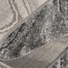 Close-up of folded gray textured rug corner