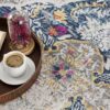 Coffee and book on colorful floral rug