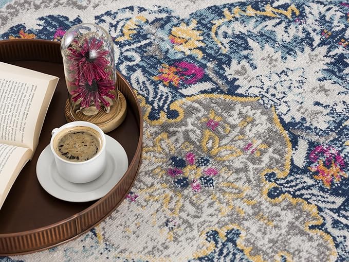 Coffee and book on colorful floral rug