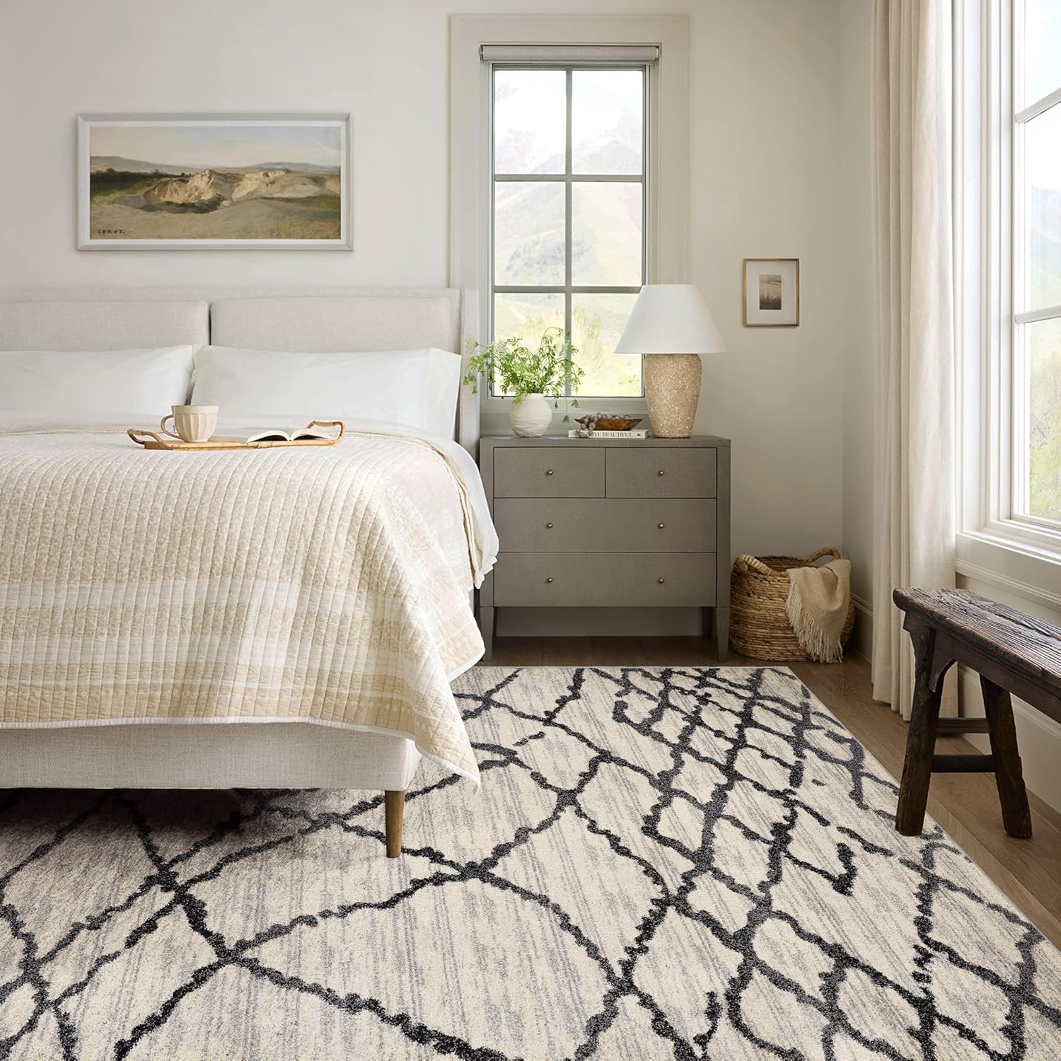 Cozy bedroom with modern decor and abstract rug.