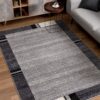 Modern living room with gray rug and furniture.