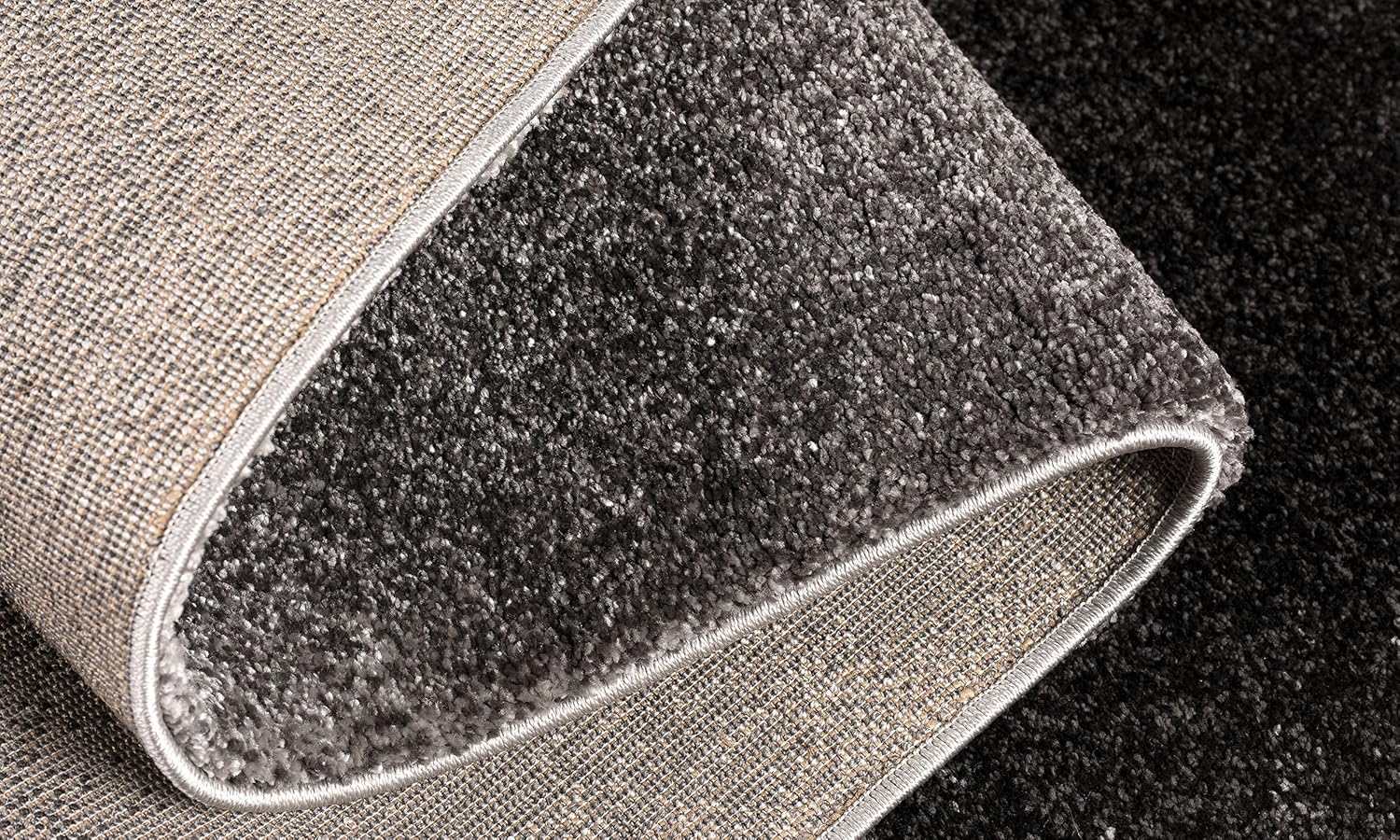 Folded gray carpet with textured backside