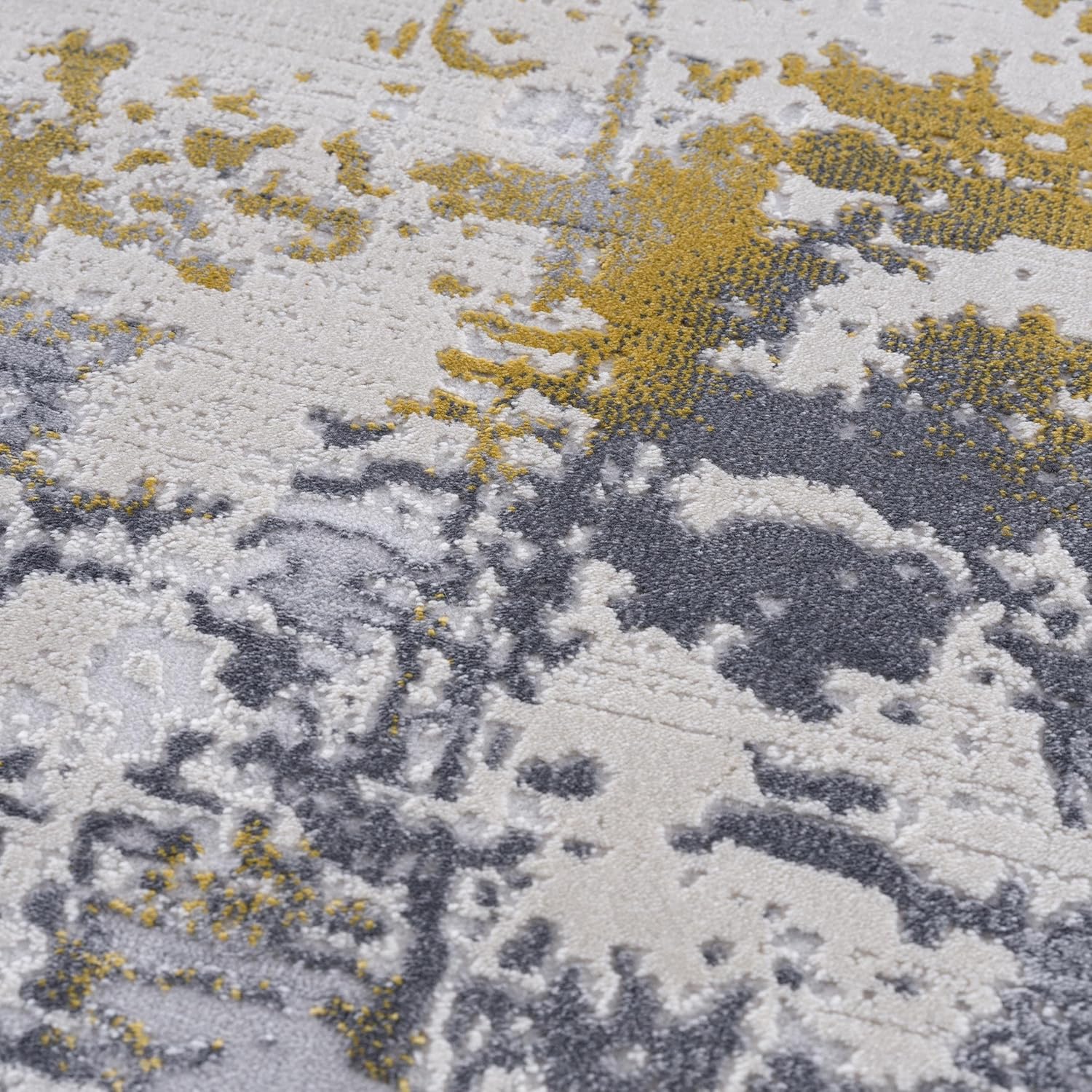 Abstract textured rug in gray, white, and yellow.