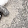 Decorative vases on patterned gray rug