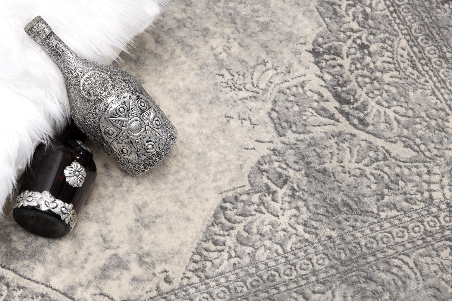 Decorative vases on patterned gray rug