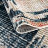 Colorful textured area rug folded over edge.