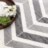 Open book on modern geometric rug with flowers.