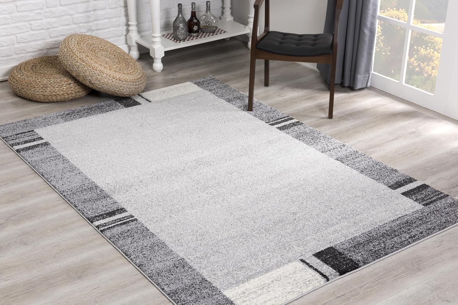 Modern gray rug with geometric pattern on floor.