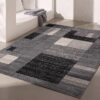Modern geometric gray area rug in minimalist room.