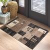 Geometric area rug in modern entryway.