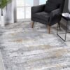 Gray armchair, abstract rug in bright room.