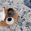 Coffee and candle on woven mat on rug.