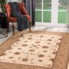Elegant floral-patterned rug and orange chair by window.