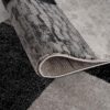 Gray and black patterned carpet texture close-up.