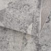 Folded gray patterned carpet design close-up