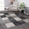 Modern living room with gray geometric rug.